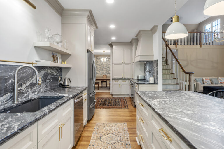 A remodeled kitchen showing island and appliances as well as new cabinets