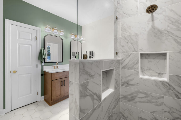 View of shower with vanity in the background