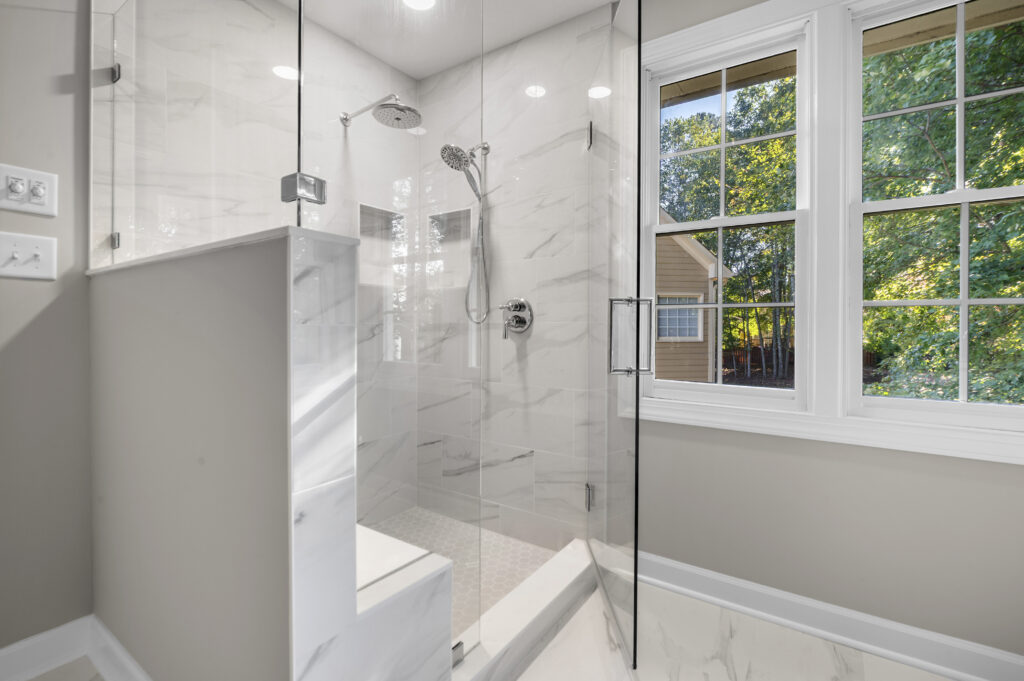 Renovated shower with bench and multiple shower heads
