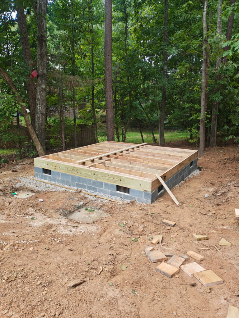 Crawlspace and floor joists on an exterior detached building that will be used as a dedicated office space