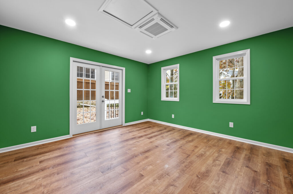 Interior of the detached office showing french doors, windows, finished flooring and walls