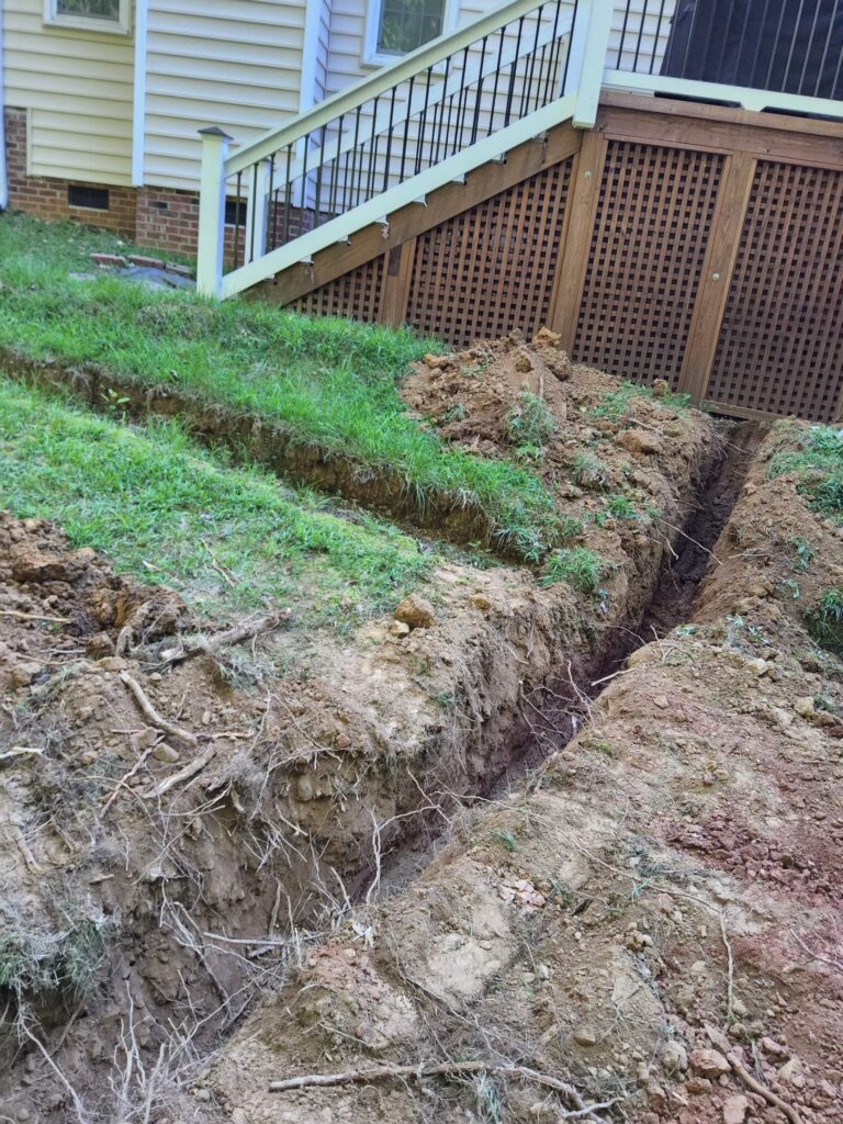 Trenches in the yard where electrical wiring will be run to reach the exterior detached office