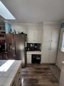 Kitchen fridge and pantry before being remodeled