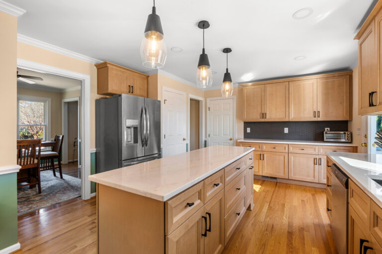 In-House Remodeling Teams vs. Subcontractors: What To Know. Kitchen after remodel which shows an expanded footprint, more storage and updated finishes.