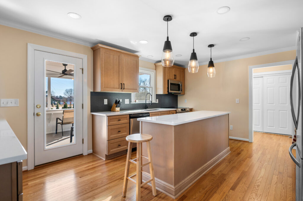 Kitchen after being remodeled that shows an expanded work area with additional storage. 