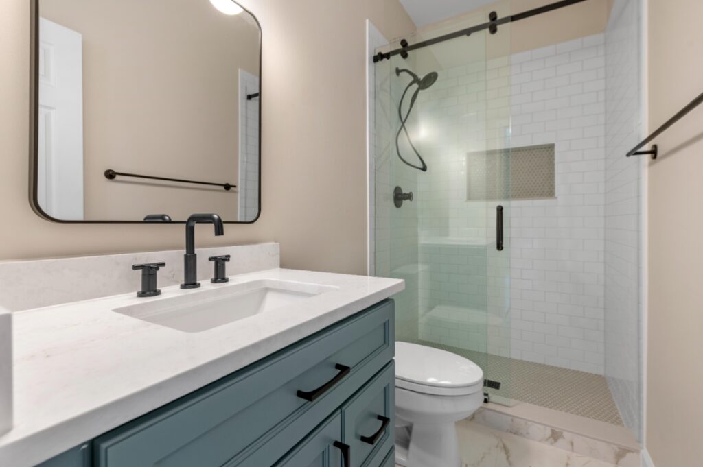 Newly installed tiled shower and updated vanity