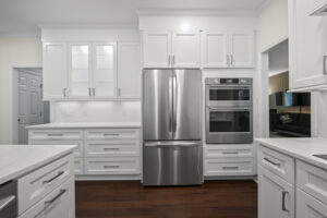 Remodeled kitchen showcasing the refrigerator, built in oven and microwave, and cabinets