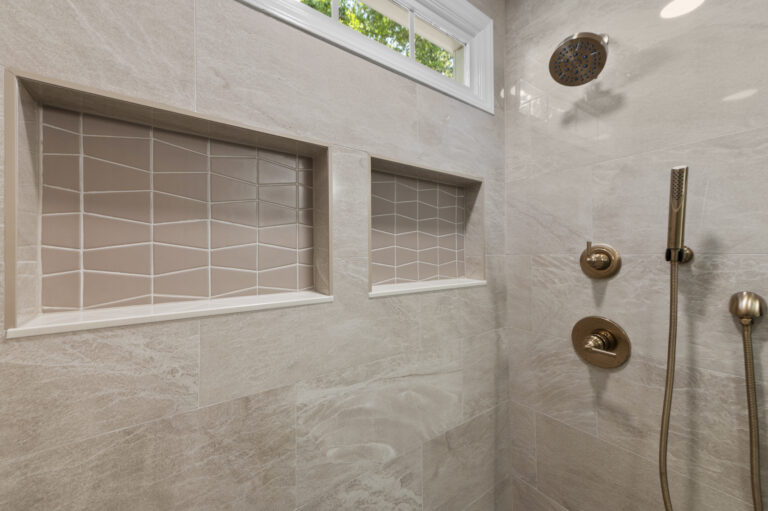 Shhower focusing on shower plumbing fixtures and recessed niches.